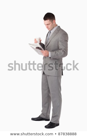 Foto stock: Portrait Of A Businessman Holding A Newspaper While Drinking Coffee Against A White Background
