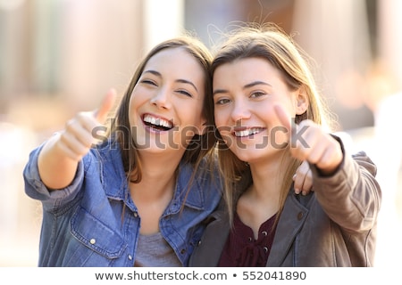 Stock photo: Smiling Young Woman With A Winning Attitude