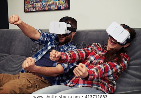 Foto stock: Shocked Bearded Young Man Wearing Virtual Reality Device