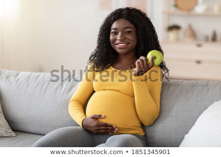 Сток-фото: Happy Pregnancy Woman Sitting On Sofa With Green Apple Healthy