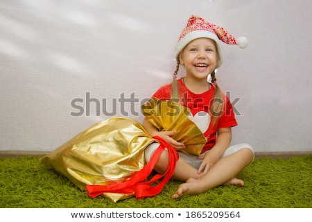 Foto stock: Enina · loira · com · chapéu · de · Papai · Noel · e · sacola · de · presente