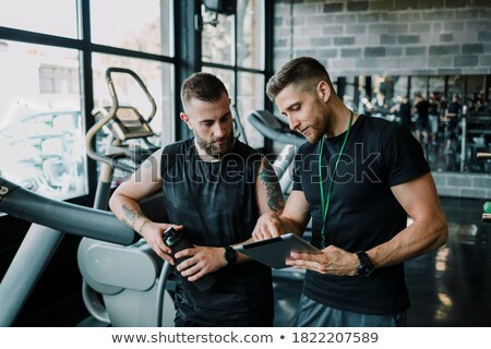 Zdjęcia stock: A Personal Trainer Helping A Man On A Treadmill