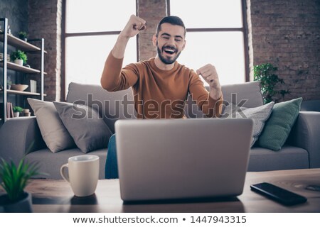 Stock fotó: Portrait A Delighted Young Man Dressed In Sweater