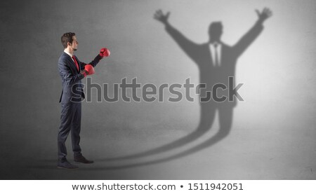 Stockfoto: Businessman Fighting With A Disarmed Businessman Shadow