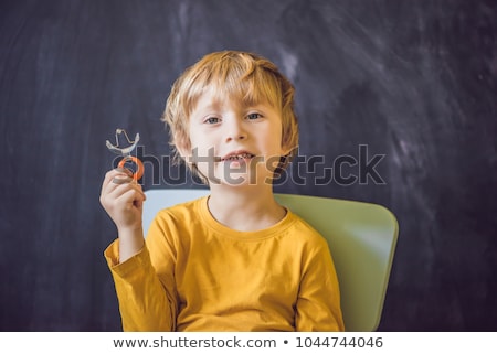 Stock photo: Three Year Old Boy Shows Vestibular Plate Plate With A Bead To Stimulate The Tongue Dysarthria Rh