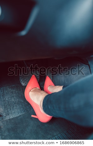 Stock foto: Woman Driving A Car In An Unsafe Manner With High Heel Shoes