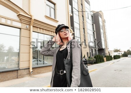 A Young Woman In Pink Glasses Near A White Building Stok fotoğraf © Alones