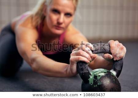 Stock photo: Portrait Of Young Woman Having A Short Break In Her Kettlebell C