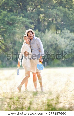 Сток-фото: Couple With Rackets In Country Field