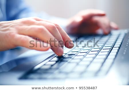 Foto d'archivio: Closeup Image Of A Male Hands Typing On Laptop Keyboard