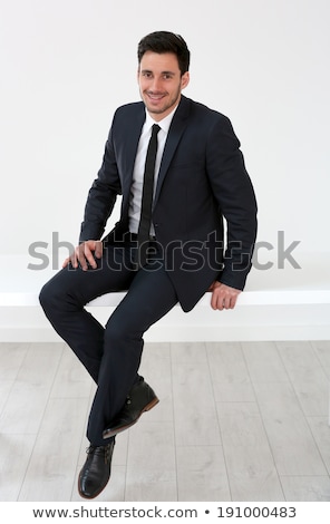 Foto d'archivio: Old Business Man Sitting In Studio And Smiles