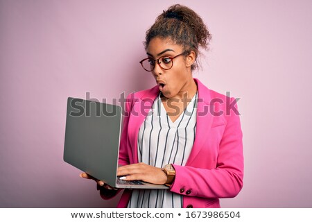 Stock photo: Worried Shocked Teenage Girl In Glasses Using Laptop