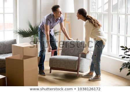 Stock photo: Couple Moving Armchair