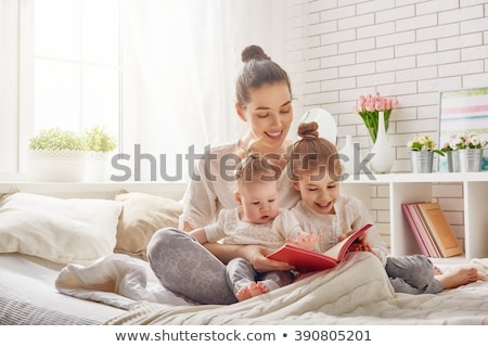 Stock fotó: Little Girls Or Sisters Reading Book In Bed