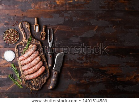 Stock foto: Raw Beef And Pork Sausage On Old Chopping Board With Vintage Knife And Fork On Dark Wooden Backgroun