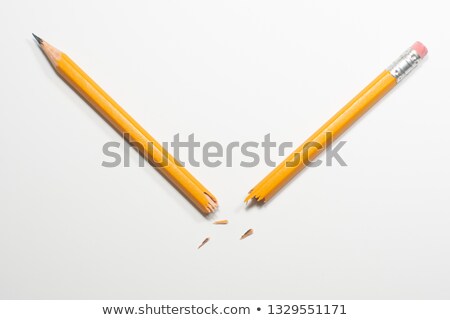 [[stock_photo]]: Broken Pencil Fragments On Yellow Paper