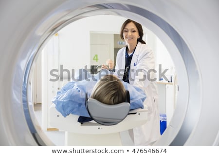 Foto stock: Nurse Smiling With X Ray