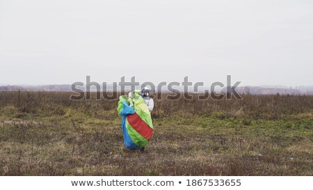 Foto stock: Man In Suit Jumping On The Wing Of An Airplane