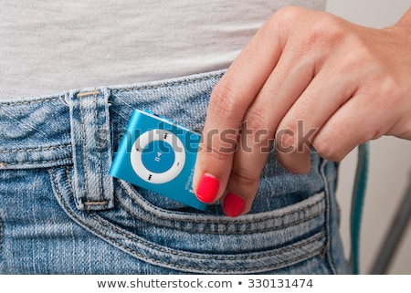 Сток-фото: Woman Listening To A Portable Mp3 Player