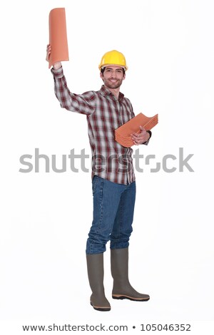 Foto stock: Roofer Stood Displaying Replacement Tiles