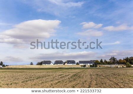 Foto stock: Noise Protection Wall With Field And Houses