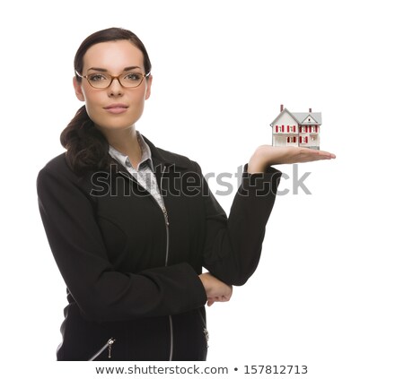 Foto stock: Mixed Race Businesswoman Holding Small House To The Side