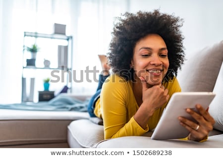 Foto stock: Woman Reading On A Tablet At Night