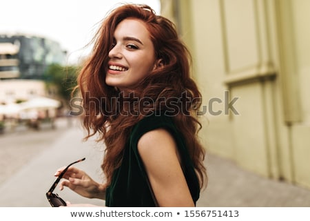 Stok fotoğraf: Young Red Woman With Beautiful Smile And Green Dress