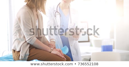 Stockfoto: Cheerful Female Doctor With Clipboard