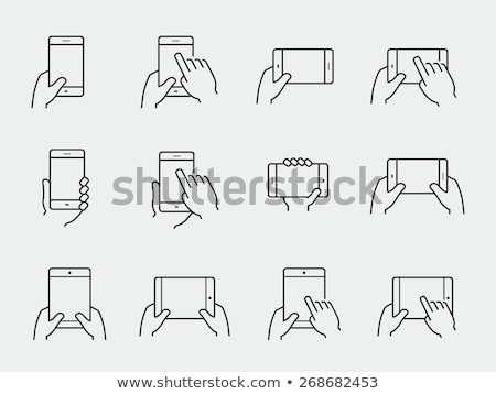 Stok fotoğraf: Hand Holding Smartphone With Icons And Symbols Concept