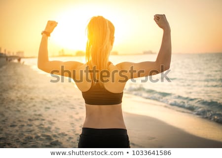 Stok fotoğraf: Female Athlete Flexing Muscles