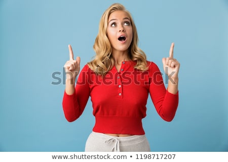 Foto stock: Portrait Of Optimistic Blond Woman 20s Wearing Red Shirt Pointin