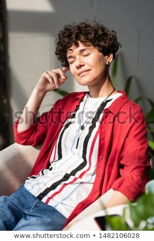 Zdjęcia stock: Young Delighted Woman In Smart Casual Sitting In Armchair After Work