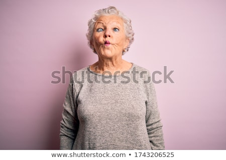 Stock photo: Senior Woman With Pink Hair And Facial Gesture