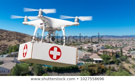Stock photo: Unmanned Aircraft System Uav Quadcopter Drone Delivering Box W