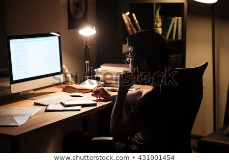 [[stock_photo]]: Man With Notepad Working Late At Night Office