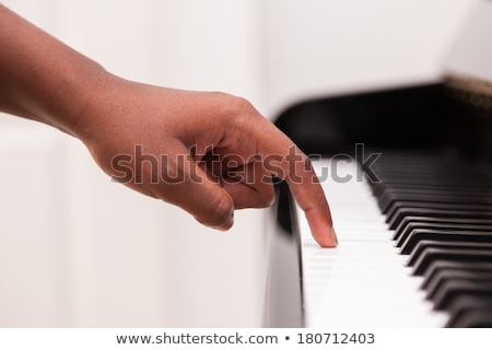 Foto stock: African American Hand Playing Piano - Touching Piano Keys - Blac