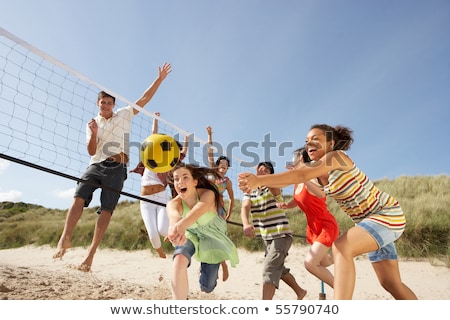 Foto stock: Group Of Friends Playing Volleyball