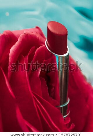 Stok fotoğraf: Red Lipstick And Rose Flower On Liquid Background Waterproof Gl