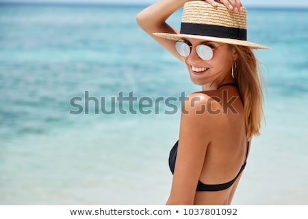 Stock photo: Beautiful Girl In Bikini And Straw Hat Smiling At Camera On Beac