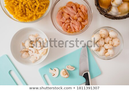 Stockfoto: Onions With Raw Fettuccine On Chopping Board