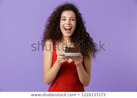 Stock foto: Image Of Happy Woman 20s Wearing Red Dress Smiling And Eating Ch