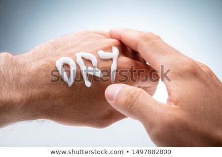Stock foto: Dry Text Made With Lotion On Human Hand