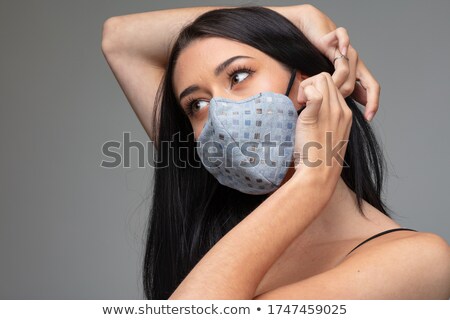[[stock_photo]]: Young Woman Adjusting A Trendy Textile Face Mask