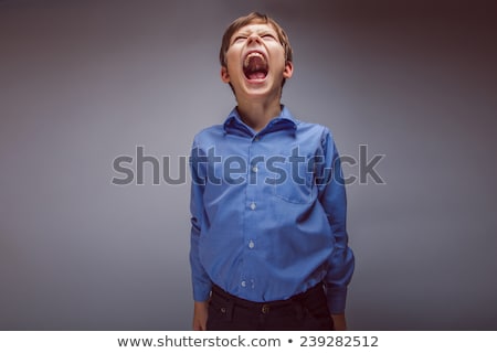 Stok fotoğraf: A Boy Screaming Loud With Mouth Wide Open