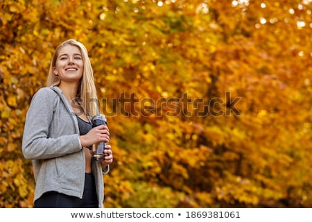 Foto stock: Blond Woman Running Outdoors On A Cold Winter Day