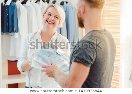 ストックフォト: Tailor Handing Over Finished Bespoke Shirt To Customer