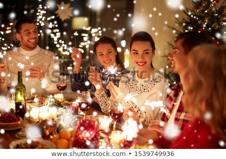 Stockfoto: Happy Friends Celebrating Christmas At Home Feast