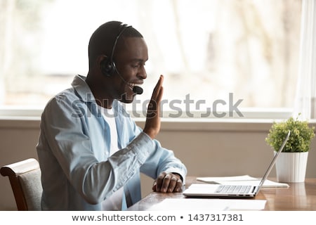 Stock photo: Man Talking Through Headphones