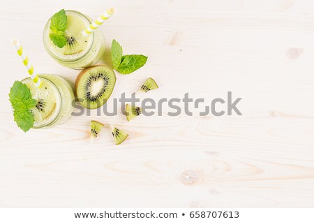 Stock photo: Decorative Frame Of Green Kiwi Fruit Smoothie In Glass Jars With Straw Mint Leaf Cute Ripe Berry